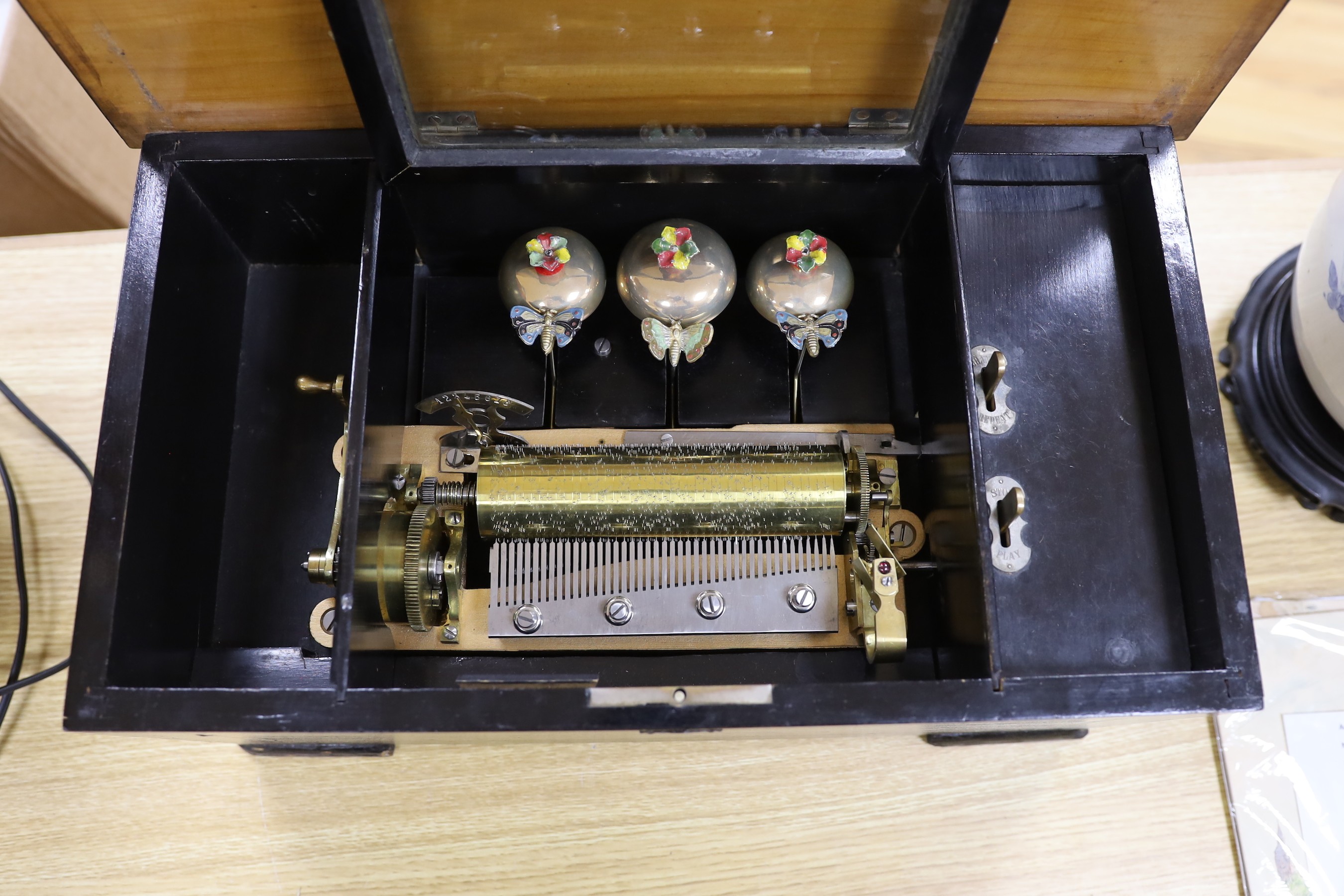 A late 19th century music box, with visible bells movement, 47cms wide, 27cm deep